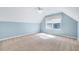 Spacious bedroom with neutral carpet, ceiling fan, and bright window providing ample natural light at 5045 Homeplace Dr, Apex, NC 27539