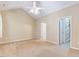 Neutral-toned bedroom featuring a ceiling fan and walk-in closet at 5045 Homeplace Dr, Apex, NC 27539