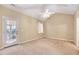 Inviting bedroom with vaulted ceilings, fan, natural light and access to the outdoor porch at 5045 Homeplace Dr, Apex, NC 27539