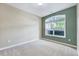 Bright bedroom featuring neutral carpet, natural light, and soft, serene paint colors at 5045 Homeplace Dr, Apex, NC 27539