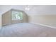 Large, carpeted bonus room with good natural light is ready for customization at 5045 Homeplace Dr, Apex, NC 27539
