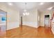 Sunlit dining room featuring hardwood floors and trim work with views of other rooms at 5045 Homeplace Dr, Apex, NC 27539