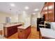 Bright kitchen area with island seating, modern appliances, and sleek countertops with wood flooring at 5045 Homeplace Dr, Apex, NC 27539