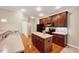 Modern kitchen boasting stainless steel appliances, an island, and ample counter space with wood floors at 5045 Homeplace Dr, Apex, NC 27539