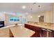 Spacious kitchen with island seating, stainless steel appliances, and a seamless transition to the living area at 5045 Homeplace Dr, Apex, NC 27539