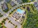 Aerial view of the community pool, clubhouse, and playground surrounded by lush landscaping at 508 White Oak Branch Ln, Apex, NC 27523