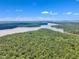 Breathtaking aerial view of green landscapes, forests, and a stunning lake at 508 White Oak Branch Ln, Apex, NC 27523