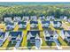 A picturesque aerial view of a community with green lawns and tree lines bordering the properties at 508 White Oak Branch Ln, Apex, NC 27523