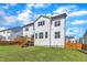 A well-kept backyard showing a wooden deck, fenced-in yard, and a view of the home's back exterior at 508 White Oak Branch Ln, Apex, NC 27523