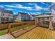 Wooden deck featuring a curtained, canopy-covered daybed and a view of the neighborhood at 508 White Oak Branch Ln, Apex, NC 27523