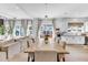 Bright dining room with a long table and views of the backyard at 508 White Oak Branch Ln, Apex, NC 27523