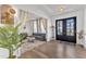Welcoming entryway with hardwood flooring, a blue sofa, and elegant curtains at 508 White Oak Branch Ln, Apex, NC 27523