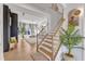 Grand staircase with wood steps, hardwood flooring, and stylish decor at 508 White Oak Branch Ln, Apex, NC 27523