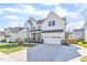 Charming two-story home with a well-manicured lawn, brick accents, and a spacious driveway at 508 White Oak Branch Ln, Apex, NC 27523