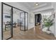 Spacious foyer featuring hardwood flooring, glass-paneled office entry, and view into the open concept living area at 508 White Oak Branch Ln, Apex, NC 27523