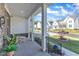 Inviting front porch with seating area, offering a relaxing view of the neighborhood at 508 White Oak Branch Ln, Apex, NC 27523