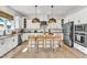 Modern kitchen features a large island and custom lighting fixtures at 508 White Oak Branch Ln, Apex, NC 27523