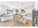 Bright kitchen with white cabinets, stainless steel appliances, and island seating at 508 White Oak Branch Ln, Apex, NC 27523