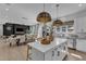 Modern kitchen with white cabinets, a large island, and pendant lighting at 508 White Oak Branch Ln, Apex, NC 27523