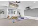 Spacious room featuring a ceiling fan, expansive screen, and soft carpet at 508 White Oak Branch Ln, Apex, NC 27523