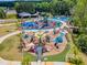 Aerial view of a colorful and extensive community playground with various play structures at 508 White Oak Branch Ln, Apex, NC 27523