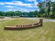 Pleasant Park community sign on a manicured green lawn with blue skies and scattered clouds at 508 White Oak Branch Ln, Apex, NC 27523