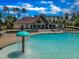 Community pool and clubhouse with seating, umbrellas, and a water feature for added enjoyment at 508 White Oak Branch Ln, Apex, NC 27523