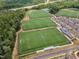 Aerial view of community soccer fields surrounded by trees and parking at 508 White Oak Branch Ln, Apex, NC 27523