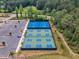 Aerial view of basketball and pickleball courts near parking and surrounded by lush trees at 508 White Oak Branch Ln, Apex, NC 27523
