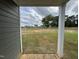 View of the expansive backyard through the covered porch with newly installed sod at 51 Commons Cir, Clayton, NC 27520