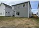 View of the home's backyard featuring newly installed sod and exterior vinyl siding at 51 Commons Cir, Clayton, NC 27520