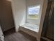 Bright bathroom with a tub next to a bright window at 51 Commons Cir, Clayton, NC 27520