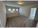 Spacious bonus room with neutral walls, plush carpeting, and natural lighting through multiple windows at 51 Commons Cir, Clayton, NC 27520