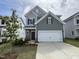 Charming two-story home with a two-car garage, manicured lawn, and professionally designed landscaping at 51 Commons Cir, Clayton, NC 27520