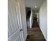 Inviting hallway with durable wood floors, stairs, and neutral paint leads to the home's main living area at 51 Commons Cir, Clayton, NC 27520