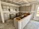 Unfinished kitchen with gray cabinets, an island, and ample space for customization at 51 Commons Cir, Clayton, NC 27520