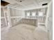 Unfinished room with bare drywall, multiple windows, and a partial wall for customization at 51 Commons Cir, Clayton, NC 27520