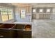 Spacious living room featuring multiple windows for ample natural light and bare drywall with cabinet details at 51 Commons Cir, Clayton, NC 27520