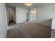 Neutral loft area with plush carpeting, providing a versatile space for a home office or recreation at 51 Commons Cir, Clayton, NC 27520