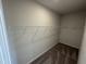 Walk-in closet with carpeting and one row of white metal shelving and racks at 51 Commons Cir, Clayton, NC 27520