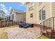 A charming brick back patio with a comfortable blue cushioned outdoor sectional set and a rustic-looking brown wooden fence at 5102 Highcroft Dr, Cary, NC 27519