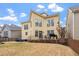 Backyard with well-maintained lawn, spacious patio for entertaining, and a charming yellow exterior at 5102 Highcroft Dr, Cary, NC 27519