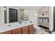 Bathroom featuring double sinks, tile floors, modern vanity, and updated fixtures for a spa-like experience at 5102 Highcroft Dr, Cary, NC 27519