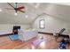 Large bonus room with hardwood floors, neutral walls, TV and sofa-- perfect for entertaining at 5102 Highcroft Dr, Cary, NC 27519