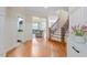 Welcoming entryway with wood floors, staircase and views into the living room at 5102 Highcroft Dr, Cary, NC 27519