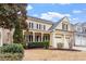Beautiful home featuring a covered porch with ceiling fans and brick accents at 5102 Highcroft Dr, Cary, NC 27519