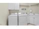 Well-organized laundry room with front-loading washer and dryer, cabinetry, and a practical folding area at 5102 Highcroft Dr, Cary, NC 27519