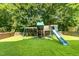 Backyard view of a wooden playset on a well-maintained lawn at 5102 Highcroft Dr, Cary, NC 27519