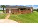 Brick home with a back patio and garden in the lawn at 5136 Liberty Grove Rd, Liberty, NC 27298