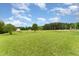 Large open backyard with a brick home and a shed at 5136 Liberty Grove Rd, Liberty, NC 27298